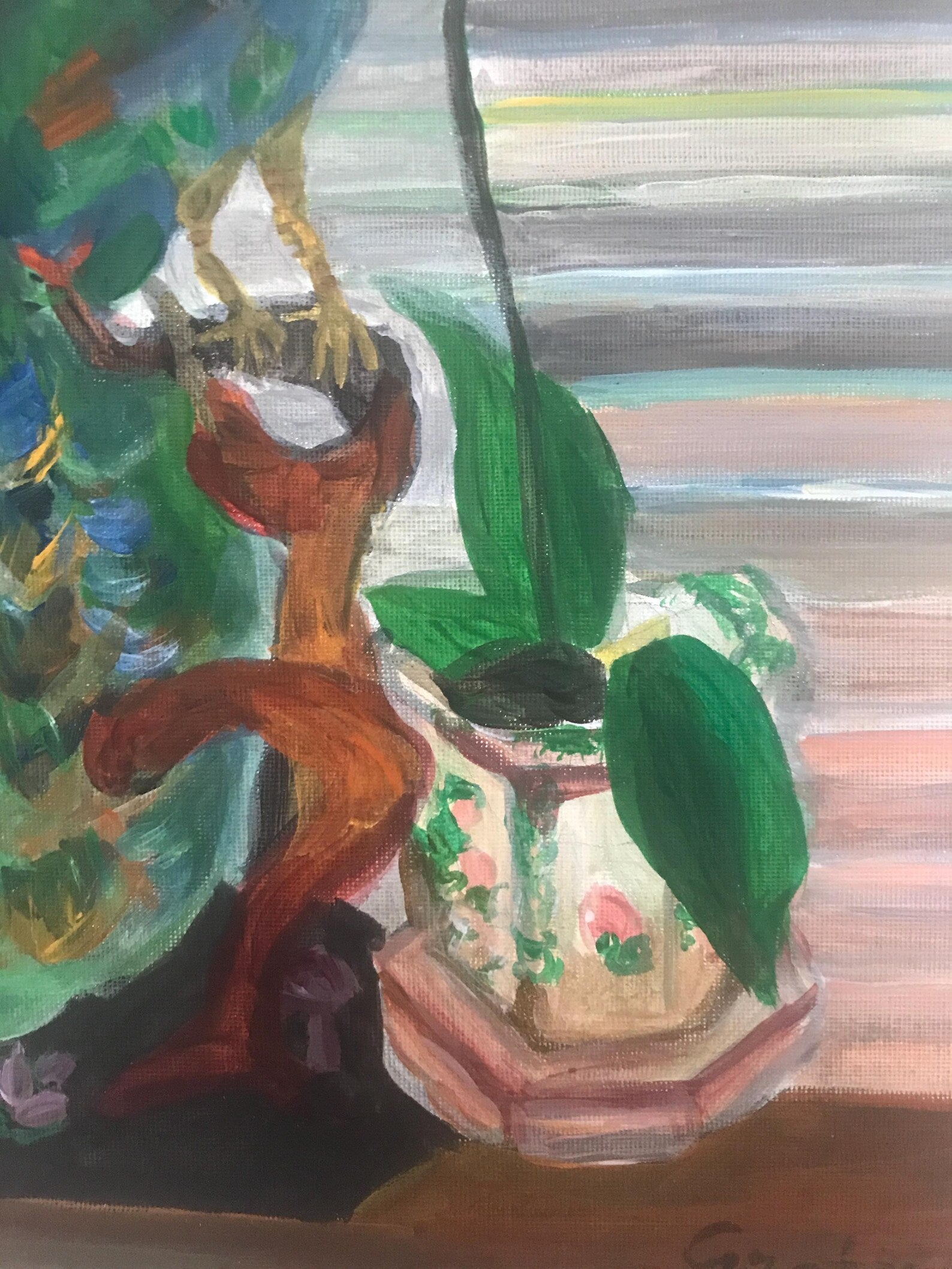 Colorful painting of a decorative vase with green leaves on a wooden surface.